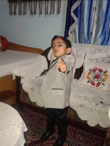 Utkarsh as a small kid in a grey blazer